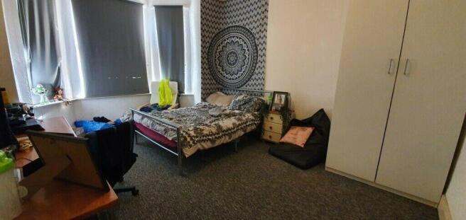 Spacious master bedroom with large bay windows...