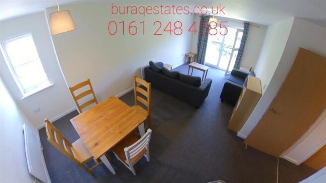 Bright, simply furnished living space with a di...