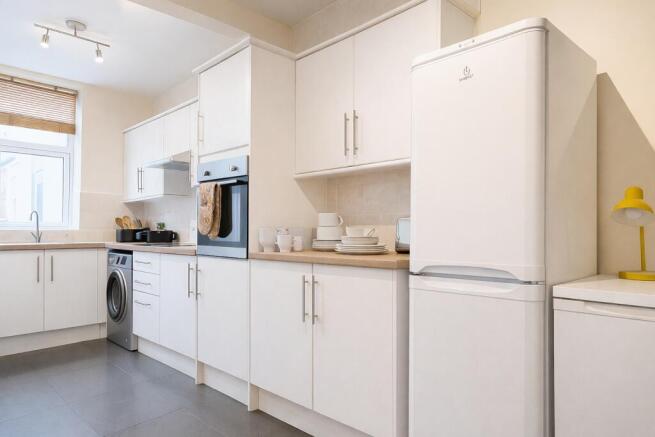 Bright modern kitchen with integrated appliance...