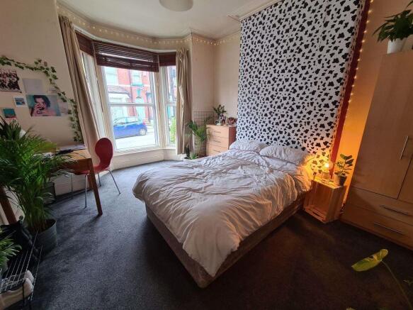 A spacious and bright master bedroom featuring ...