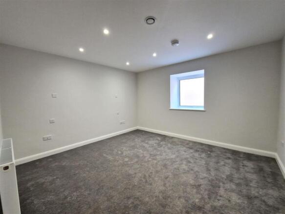 Spacious modern bedroom with plush new carpet...