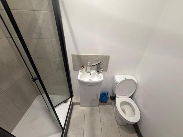 Compact modern bathroom with shower and basin...