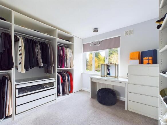 Bright, neatly arranged bedroom with built-in o...