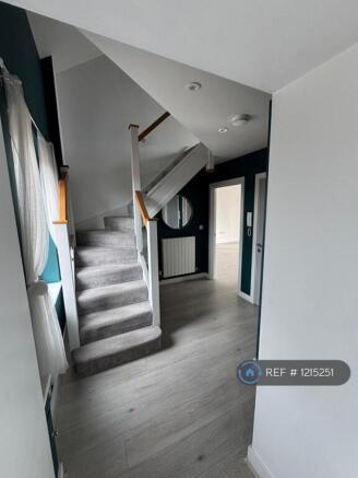 Bright Private Hallway Leads To Second Floor 