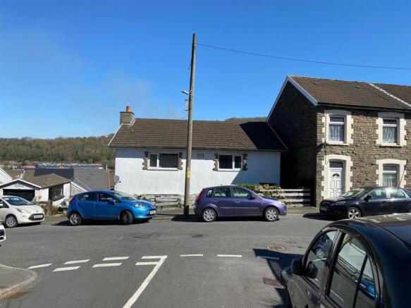 Charming stone-fronted home under clear blue sk...