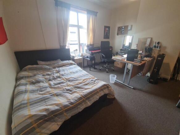 Bright and spacious bedroom featuring a large d...