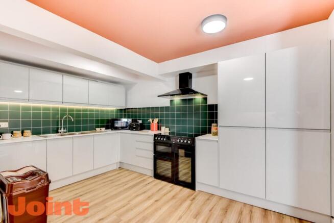 Bright modern kitchen with glossy white cabinet...