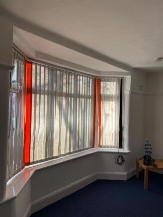 Bright bay window with elegant vertical blinds...