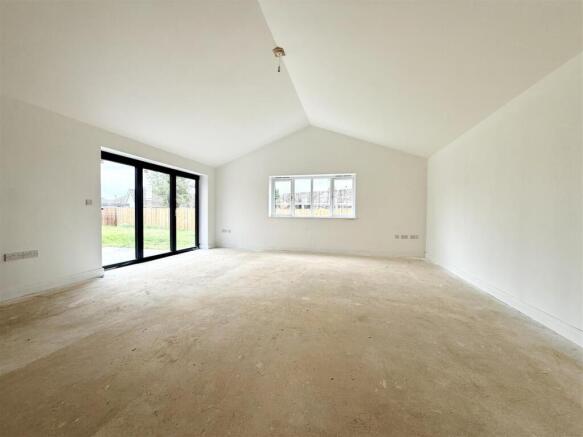 lounge with vaulted ceiling