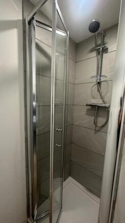 Sleek contemporary walk-in shower with grey til...