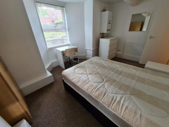 Bright, neutrally decorated double bedroom with...