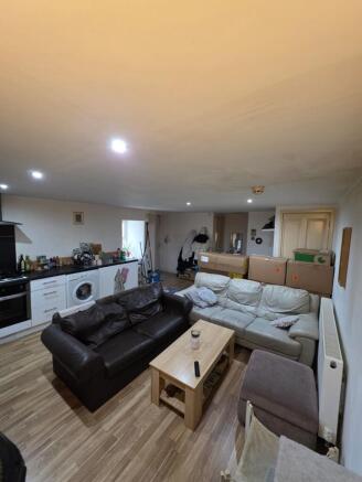 Open-plan living area with two comfortable sofa...