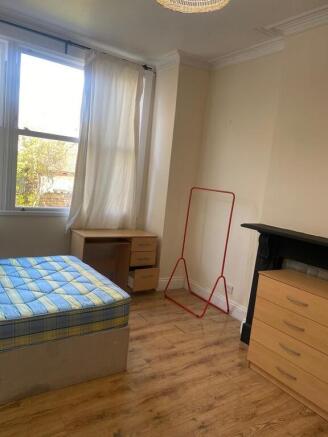 Bright bedroom with desk and ample storage...