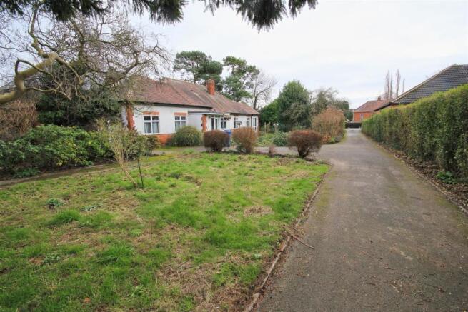 Long driveway leading to both garages