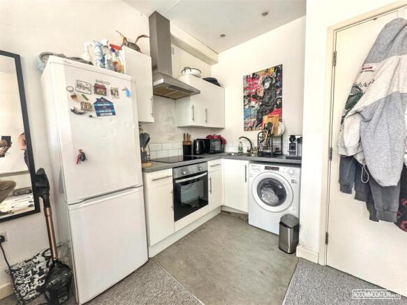 Bright modern kitchen with integrated appliance...