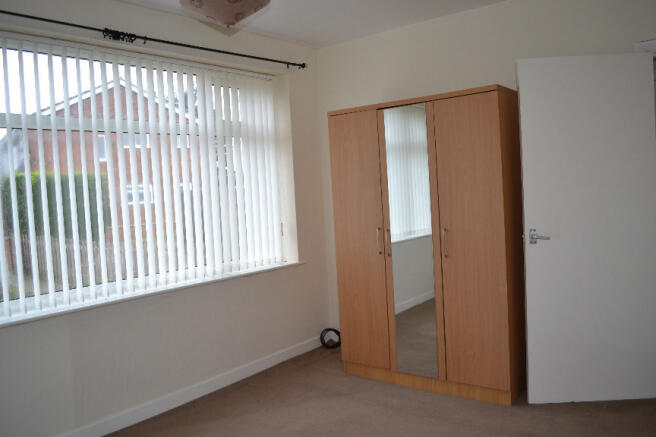 Bedroom With Large Window Overlooking Front