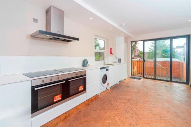 Modern kitchen with double ovens and garden vie...