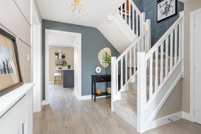 A welcoming entrance hall with feature staircase