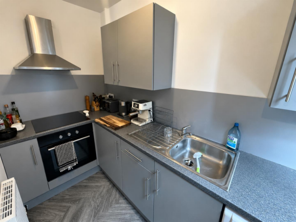 Modern Grey Kitchen with Stainless Steel Accents.p