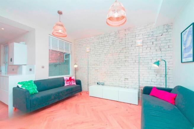 Modern living room with stylish exposed brick w...