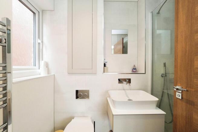 Stylish Shower room en suite with heated towel holder and flush storage cupboard