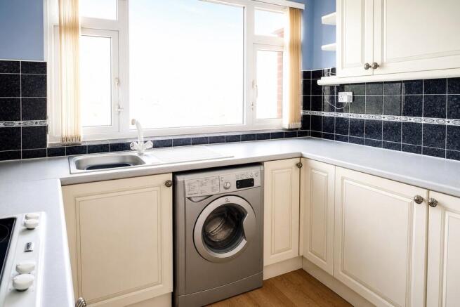 Bright kitchen with laundry and ample counter s...