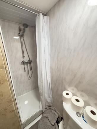 A clean and functional bathroom featuring a sho...