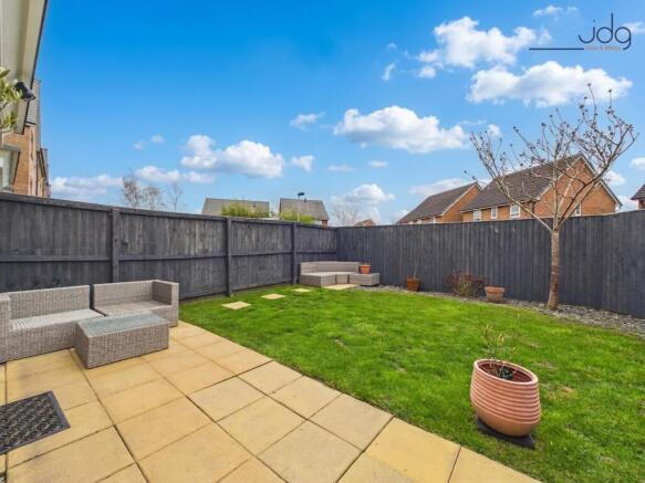 South-facing garden with a lawn and patio
