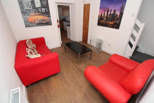 Cosy lounge with vibrant seating and wood floor...