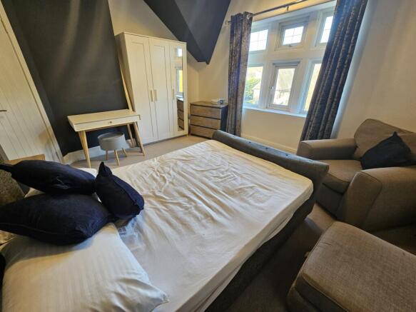 A spacious and inviting master bedroom featurin...