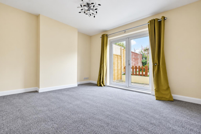 Bright Empty Room with Garden Doors.png