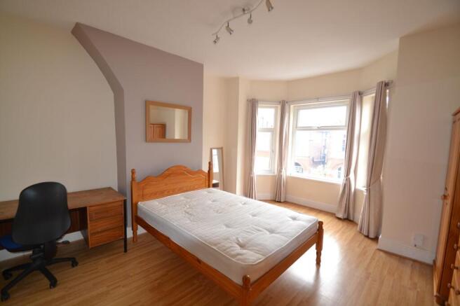 Bright and welcoming bedroom with large windows...