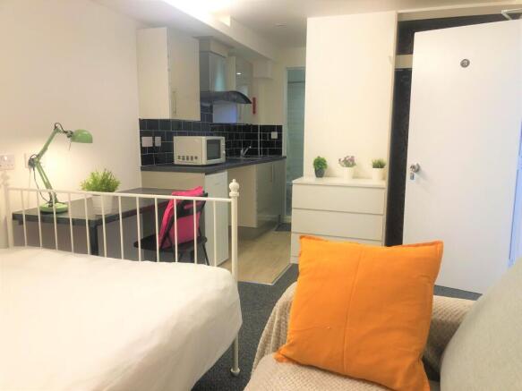 Bright and inviting single bedroom with a cozy ...