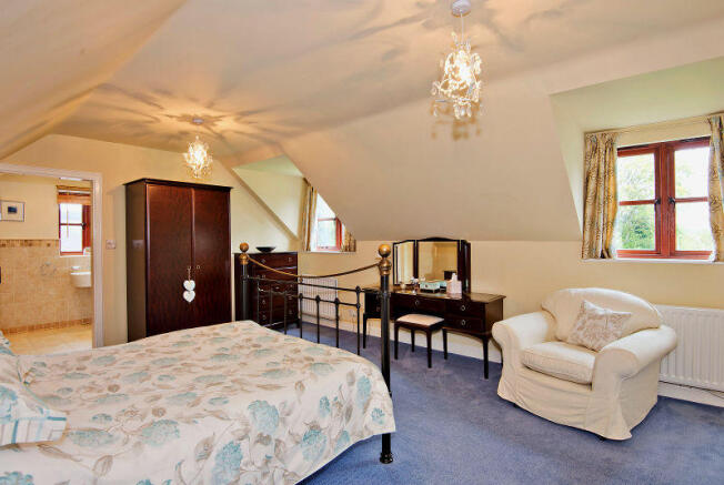 Large Master Bedroom with dormer windows overlooki