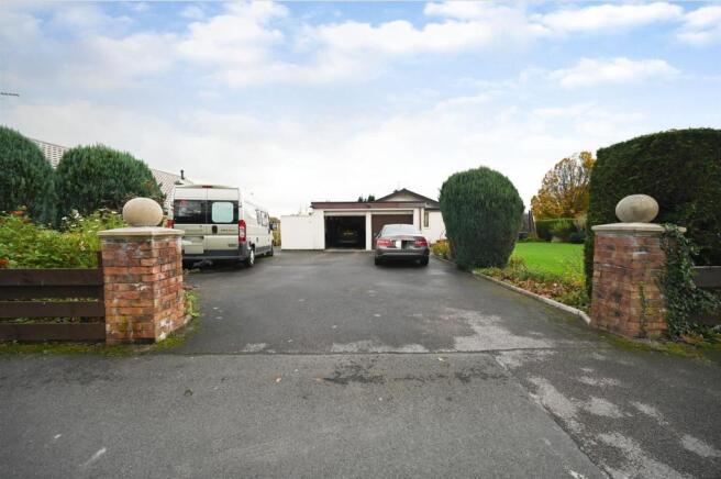 LARGE DRIVEWAY LEADING TO GARAGE