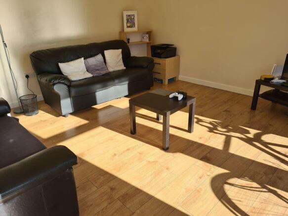 A bright and inviting living room featuring com...