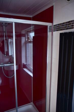 A clean, modern bathroom with a shower enclosur...