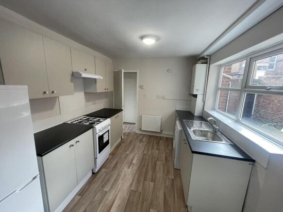 Bright, modern galley kitchen with large window...