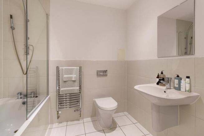 Step into this stylish bathroom with modern amenities and clean lines.