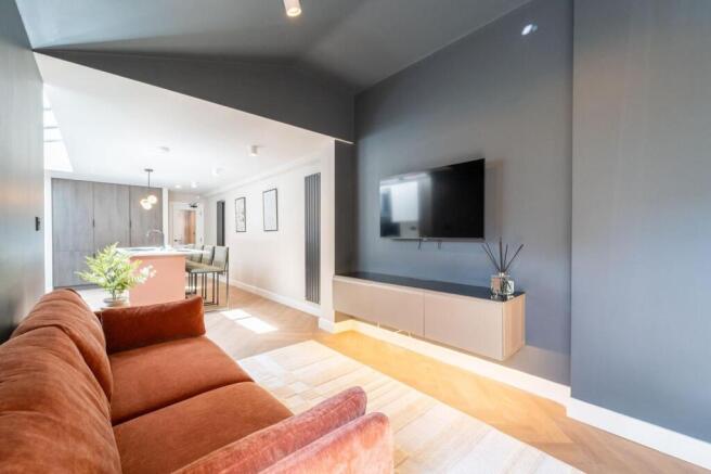 Stylish open-plan lounge with chic designer sof...