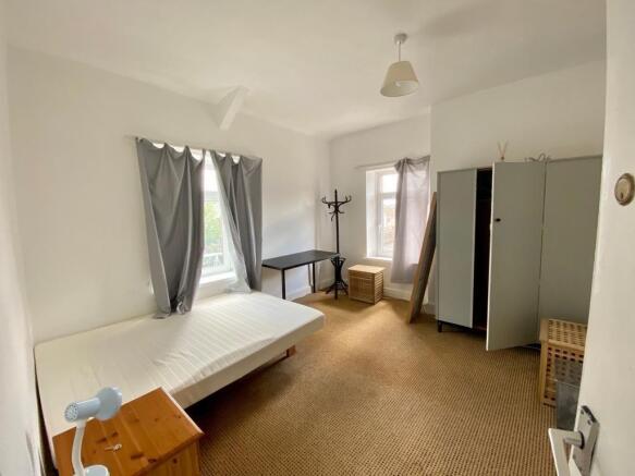 Bright spacious bedroom with ample storage spac...