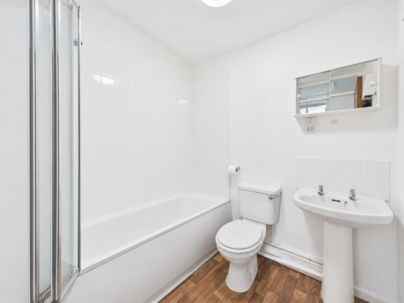 Freshly cleaned bathroom with white tiles