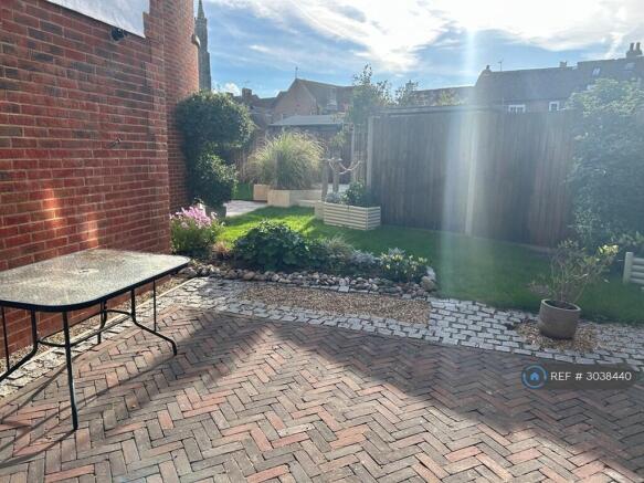 Side Patio From Utility Room And Access To Garage 