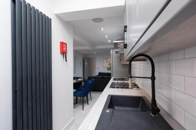 A modern and clean kitchenette with stylish fin...