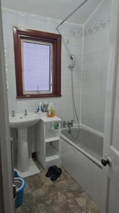 Bright bathroom with bathtub and storage space...