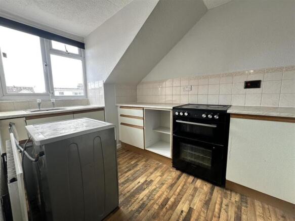 Bright kitchen with modern oven and wood floors...