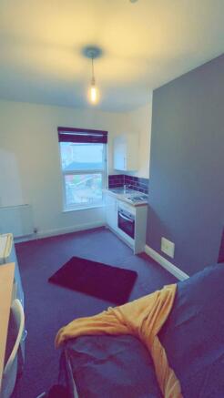 Compact open-plan living space with a fitted ki...