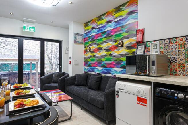 Bright, stylish communal lounge with a comforta...