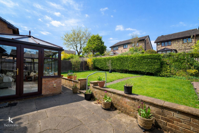 Sunny garden patio with conservatory.png
