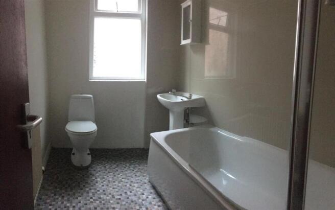 Bright, straightforward bathroom featuring a ba...